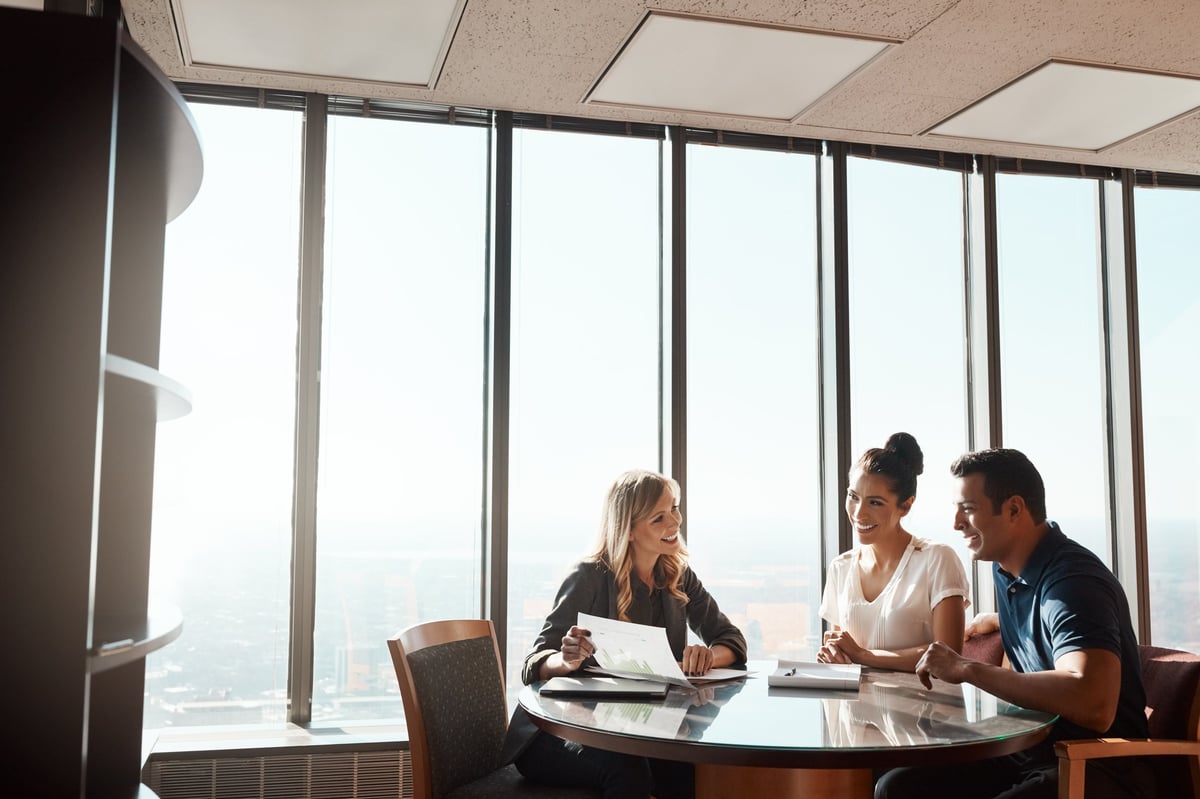A consultant meeting with a client team in a modern office